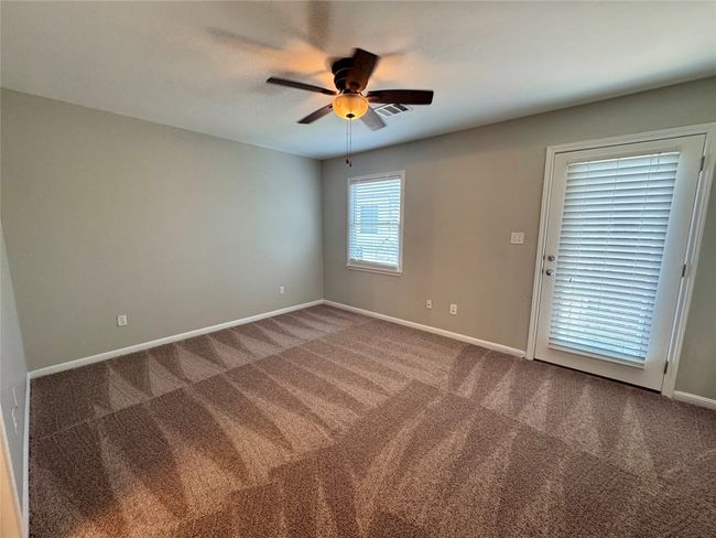 Carpeted empty room featuring ceiling fan and baseboards | Image 14
