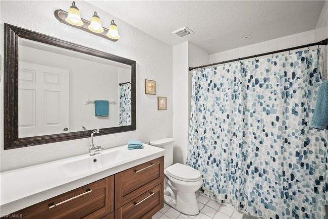 Full bath with toilet, vanity, a textured ceiling, tile patterned flooring, and visible vents | Image 20