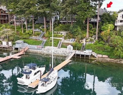 Shared deep water dock sits on the north property line and is shared with the neighbor. An oversized deck at the waters edge. Lots of fun to be had in the sunshine. Launch your kayaks or take a dip in the water! | Image 2