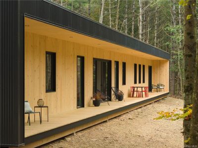 Rear view of house with a wooden deck | Image 1