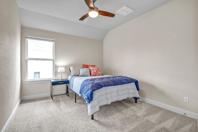 Carpeted bedroom with lofted ceiling and a ceiling fan | Image 30