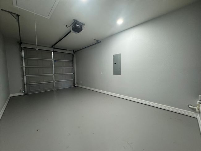 Garage featuring electric panel and a garage door opener | Image 20