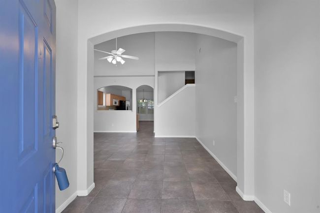 Upon entering, you’re greeted by a formal entry adorned by an arched opening that leads into the main living area. Fresh paint throughout! | Image 4