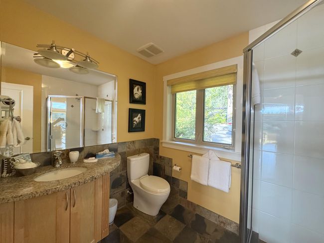 Bathroom with vanity, a shower stall, and tile walls | Image 20