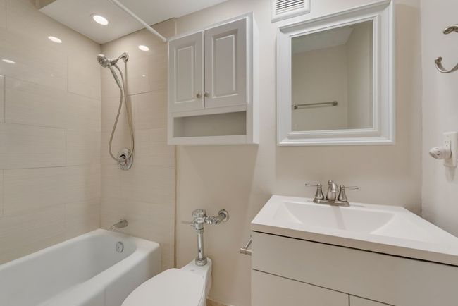 Full bath featuring vanity and shower / bath on tile flooring. | Image 7