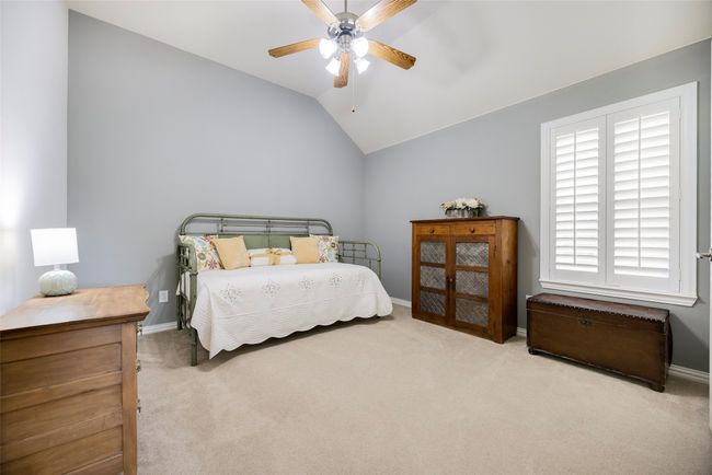 Bedroom 3 with carpet floors, vaulted ceiling, baseboards, and a ceiling fan | Image 21