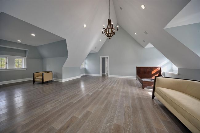 Bonus room featuring baseboards, recessed lighting, vaulted ceiling, wood finished floors, and a notable chandelier | Image 20