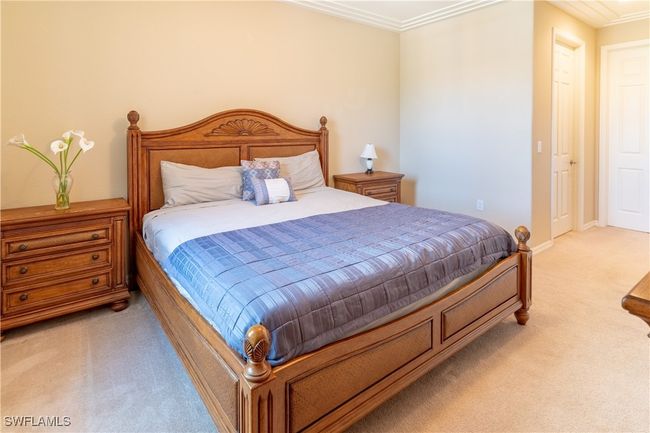 Bedroom featuring light carpet and crown molding | Image 16