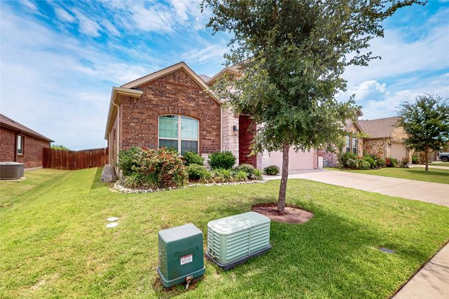View of front of house featuring concrete driveway, brick siding, and an attached garage | Image 4