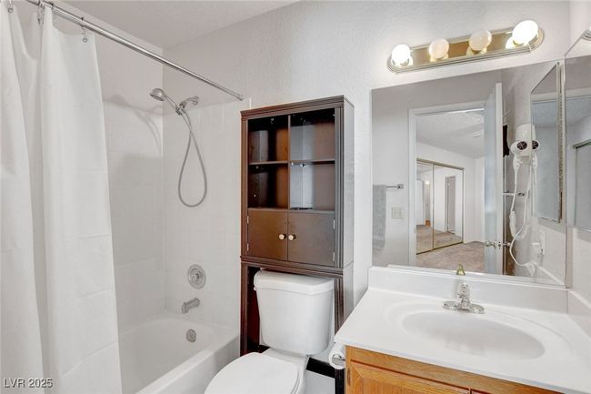 Full bathroom with toilet, vanity, and shower / bath combination with curtain | Image 23