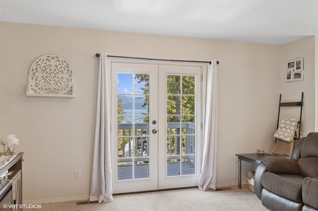 Doorway with french doors, light carpet, and baseboards | Image 12