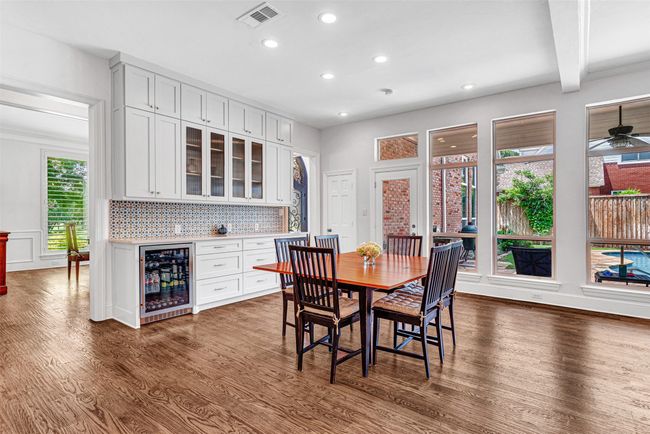 The breakfast area has also been recently renovated with custom wood cabinets and drawers, quartz counter and built-in under cabinet beverage refrigerator • Two docking drawers with hidden charging strips and electrical outlets for charging all devices out of sight | Image 9