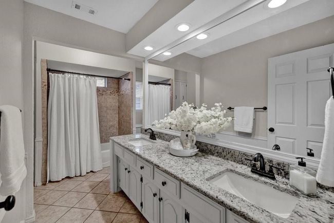 Bathroom featuring tile patterned flooring, a sink, double vanity, and visible vents | Image 24