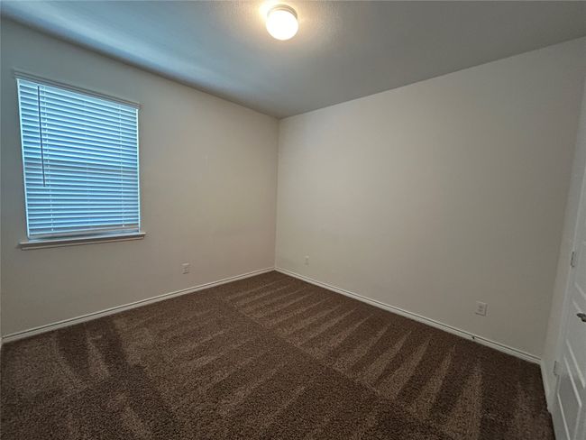 Spare room with dark colored carpet and baseboards | Image 15