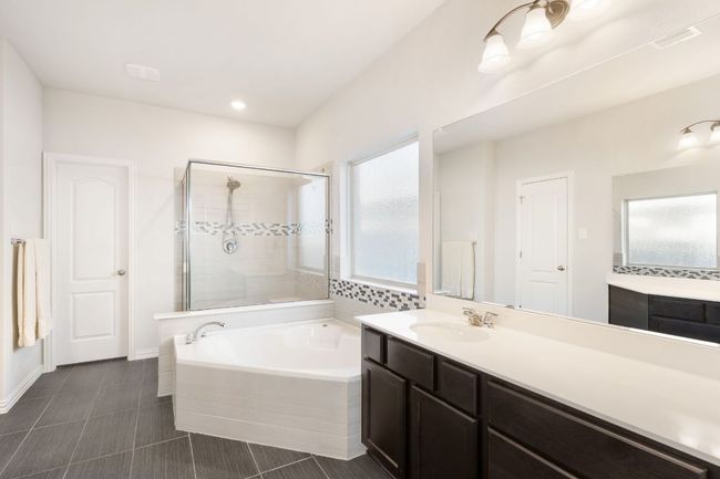 The primary bathroom has double vanities, walk-in closet and private water closet. | Image 14