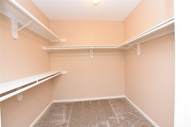 The expansive primary walk-in closets provide ample room for organization and display, ensuring that every item has its place. | Image 16