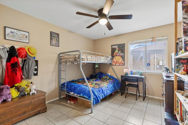 Bedroom featuring tile patterned floors, baseboards, and ceiling fan | Image 26