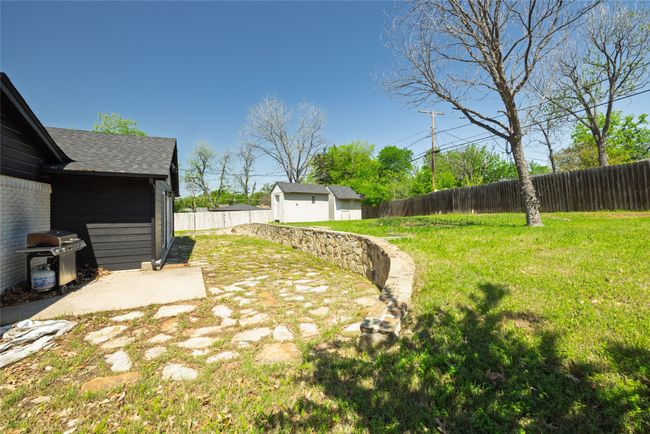 View of yard featuring an outbuilding, a fenced backyard, and a storage shed | Image 36