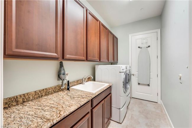 Washroom with independent washer and dryer, cabinet space, and baseboards | Image 30