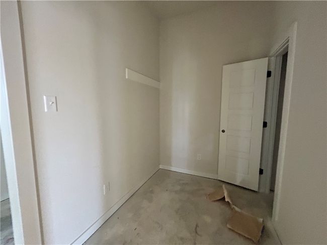 Hall with concrete flooring and baseboards | Image 16