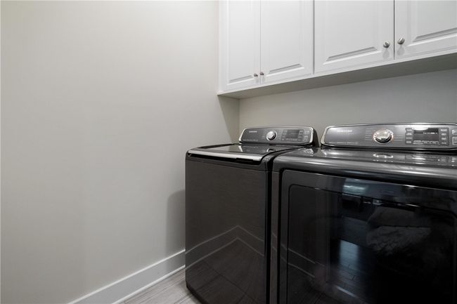 Second floor Laundry Room for convenience has upper storage cabinets and ceramic floor. | Image 30