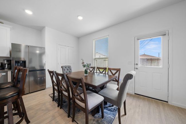 The cozy breakfast nook is open to the living area, creating a seamless flow for casual dining and conversation. | Image 12