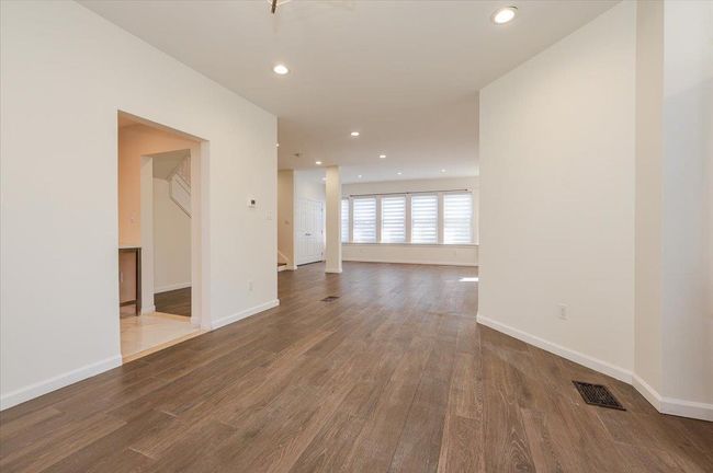 Empty room with baseboards, recessed lighting, visible vents, and wood finished floors | Image 6