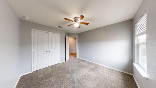 Unfurnished bedroom featuring visible vents, carpet floors, a closet, baseboards, and a ceiling fan | Image 31