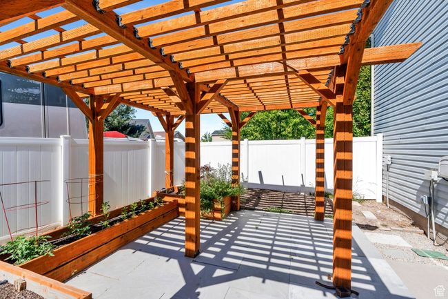 Fenced backyard with a garden, a patio, and a pergola | Image 27