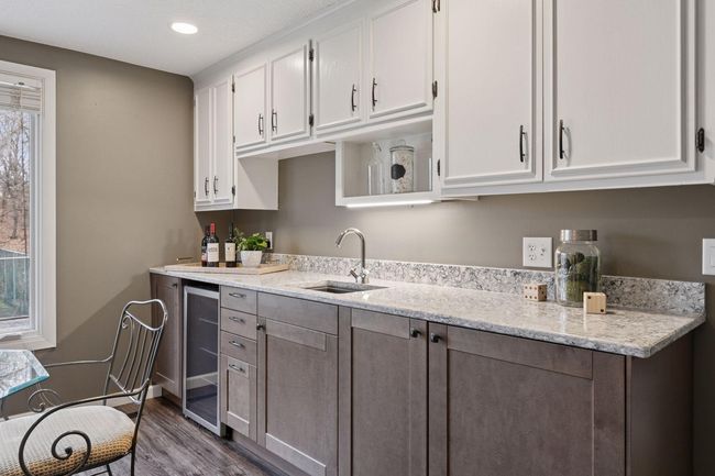 Wet bar with beverage fridge, under cabinet lighting, quartz counters | Image 32