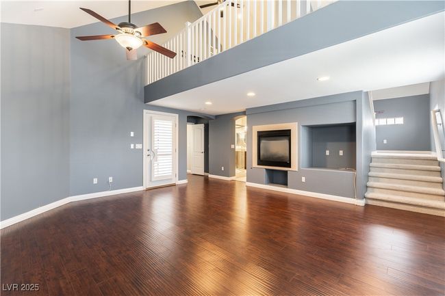 Primary bedroom with baseboards, ceiling fan, and wood finished floors | Image 23