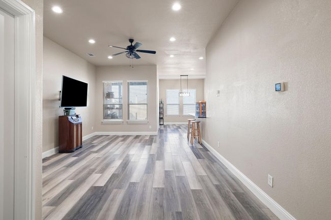 Unfurnished living room featuring recessed lighting, a ceiling fan, visible vents, and wood finished floors | Image 4