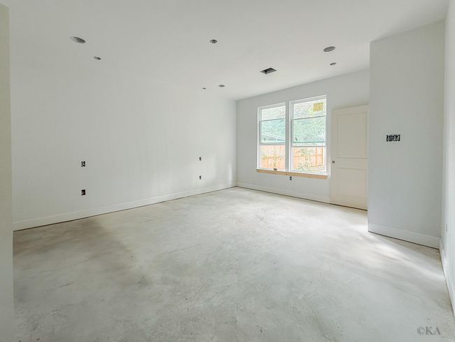 Spacious first floor primary bedroom which will feature bedside pendant lighting, a decorative ceiling fan, and cat 6 wiring. | Image 17