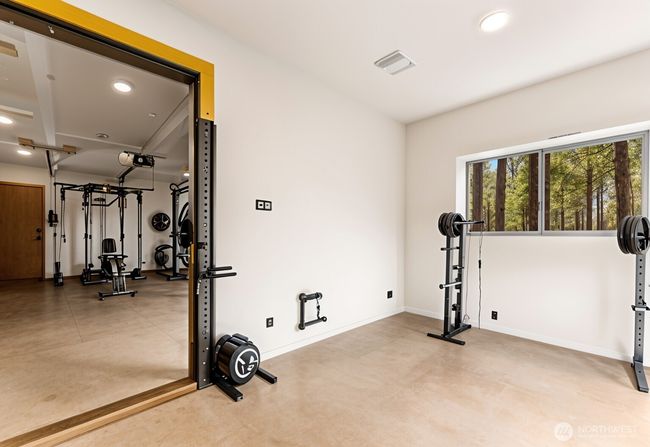 Finished heated bonus room on ground level. Put your cold plunge tub here! Virtually staged (Floor of basement is concrete, not wood). | Image 38
