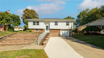 Split foyer home with a garage and a front yard | Image 1