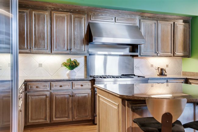 Chef's kitchen with adjacent breakfast room. | Image 12