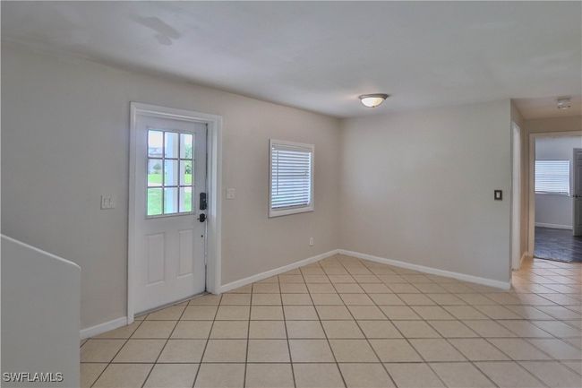Foyer entrance featuring baseboards and light tile patterned floors | Image 7