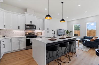 Discover seamless living in this thoughtfully designed home, where the kitchen and dining area seamlessly blend into the inviting living room. Whether you're hosting a dinner party or enjoying a quiet evening, the spacious layout provides the perfect backdrop for every occasion. | Image 1