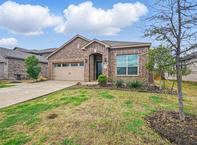 Ranch-style home featuring brick siding, a front yard, a garage, and driveway | Image 21
