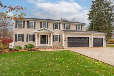 View of front of house featuring a garage and a front yard | Image 1