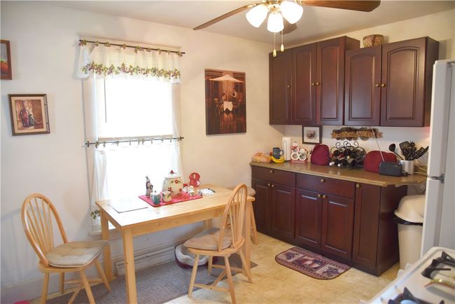 Eat in kitchen with cherry cabinets and appliances | Image 9