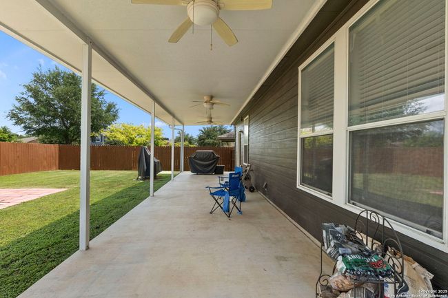 Large covered cement back patio deck. | Image 27