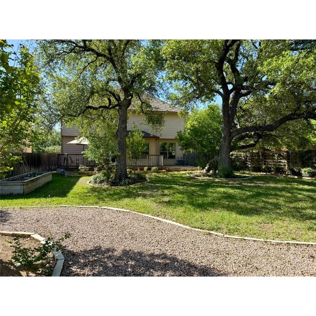 Backyard has great landscaping and large shade trees | Image 5