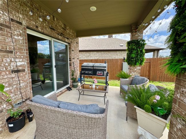 View of patio with an outdoor hangout area | Image 30