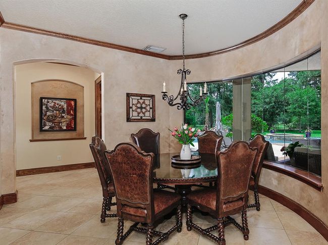 Sunny breakfast room with large windows overlooking the backyard and golf course | Image 16