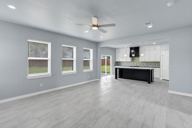 Unfurnished living room with ceiling fan and recessed lighting | Image 11