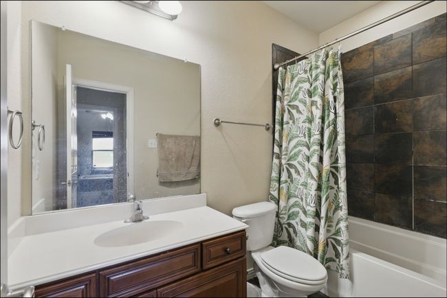 Bedroom with dark carpet and a ceiling fan | Image 33