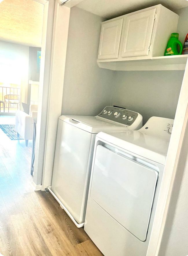 Washroom featuring washer and clothes dryer, cabinets, and light hardwood / wood-style flooring | Image 13