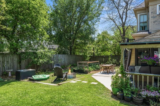 Fenced backyard featuring an outdoor fire pit and a patio area | Image 37