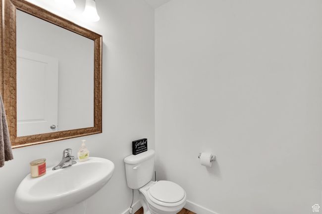 Bathroom featuring baseboards, a sink, and toilet | Image 12